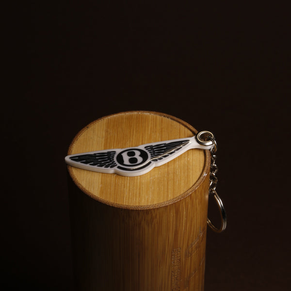 Bentley winged-B emblem keychain in acrylic on a plain background