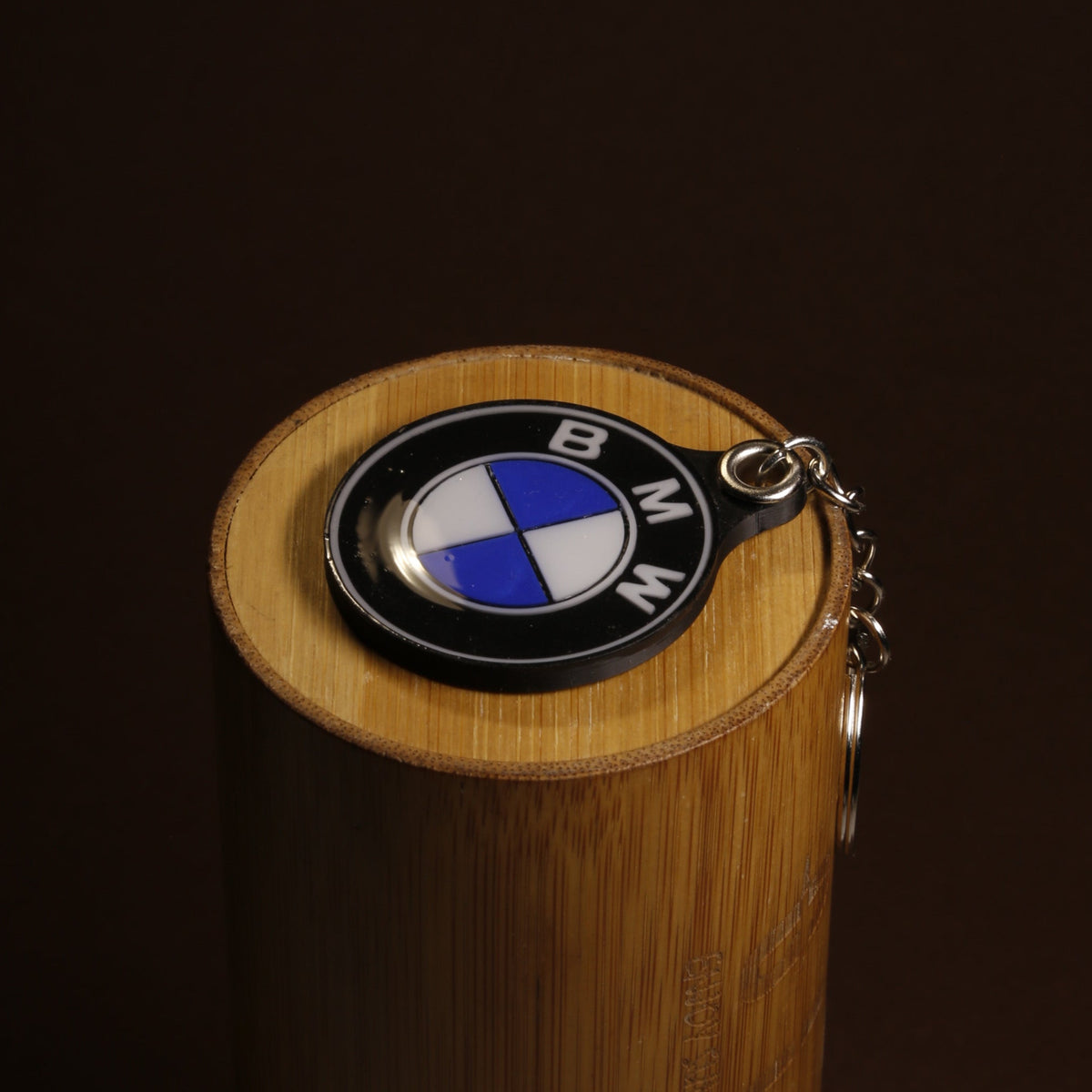 BMW roundel keychain in hard enamel on a plain background