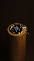 Yamaha tuning fork emblem keychain in acrylic on a plain background
