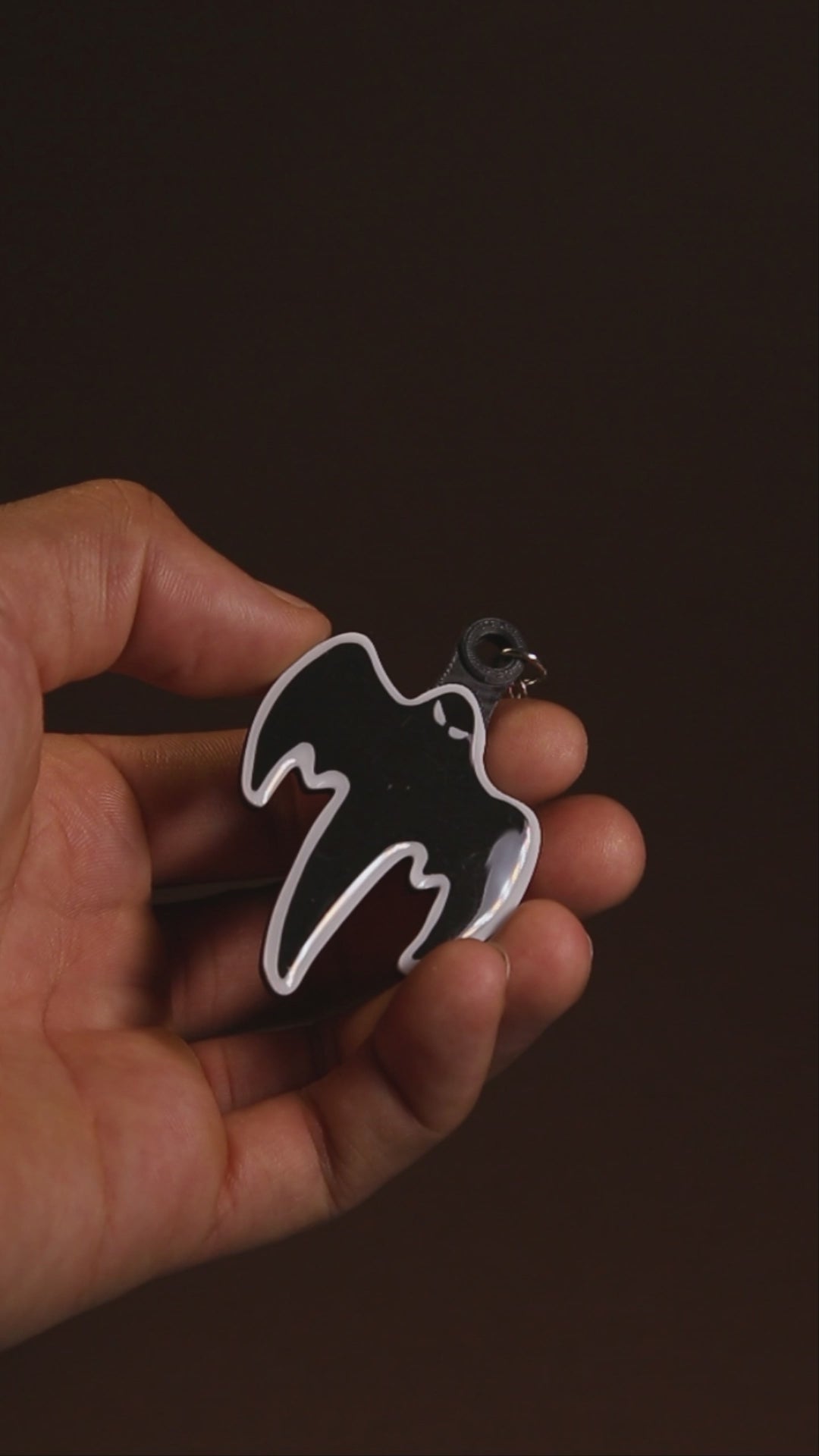 Koenigsegg ghost keychain turning to show its hand-finished gloss