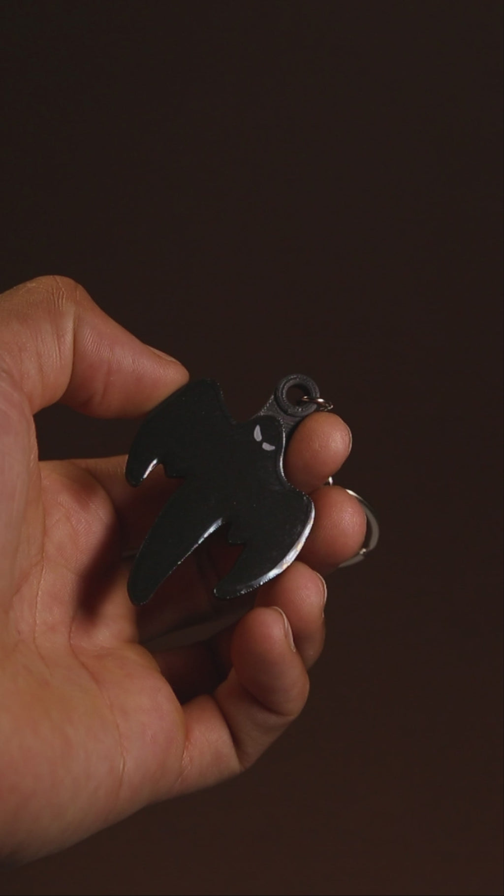 Koenigsegg ghost keychain held in hand for scale