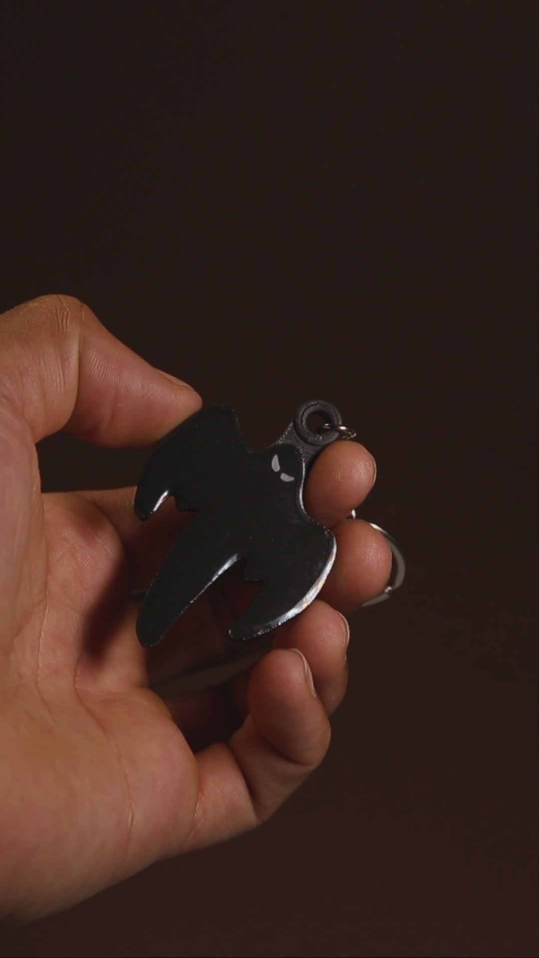 Koenigsegg ghost keychain held in hand for scale